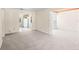 Bright, neutral living room with an open floor plan and tiled kitchen visible in the background at 417 Broadway, Dunedin, FL 34698