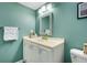 Clean bathroom featuring a classic vanity with storage and a decorative mirror at 4500 Great Lake S Dr, Clearwater, FL 33762