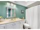 Well-maintained bathroom with a functional vanity, white cabinets, and shower with curtain at 4500 Great Lake S Dr, Clearwater, FL 33762