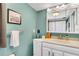 Bright bathroom with a white vanity, framed mirror, and neutral paint at 4500 Great Lake S Dr, Clearwater, FL 33762