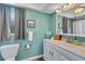 Bright bathroom with a white vanity, framed mirror, window, and neutral paint at 4500 Great Lake S Dr, Clearwater, FL 33762