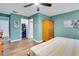 This bedroom offers ceiling fan, neutral paint, white trim, wood-look floors and an attached bath at 4500 Great Lake S Dr, Clearwater, FL 33762