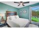 Cozy bedroom with a wood-accented headboard, plush bedding, and a view to the backyard at 4500 Great Lake S Dr, Clearwater, FL 33762