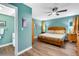 Bright bedroom with a window, ceiling fan, wood floors, bedside tables, and an en suite bathroom at 4500 Great Lake S Dr, Clearwater, FL 33762