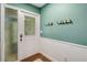 Inviting entryway featuring paneled walls, a decorative front door, and coat hooks at 4500 Great Lake S Dr, Clearwater, FL 33762