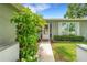 Inviting front entrance with manicured bushes and vibrant green foliage at 4500 Great Lake S Dr, Clearwater, FL 33762