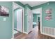 Hallway view with wood-look flooring, neutral paint and white trim at 4500 Great Lake S Dr, Clearwater, FL 33762