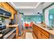 Well-lit kitchen featuring stainless steel appliances and wood cabinets overlooking a cozy adjacent living area at 4500 Great Lake S Dr, Clearwater, FL 33762