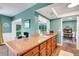 Spacious kitchen with wood cabinets and stone countertops overlooks the sunroom and dining area at 4500 Great Lake S Dr, Clearwater, FL 33762