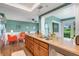 The kitchen features wood cabinetry and stone countertops, connecting to dining and living spaces at 4500 Great Lake S Dr, Clearwater, FL 33762