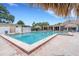 Community pool with brick accents, tiki hut, surrounded by comfortable seating at 4500 Great Lake S Dr, Clearwater, FL 33762