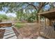 Backyard view with lush foliage, stone path, fire pit, and wooden fence at 4522 5Th St, Zephyrhills, FL 33542