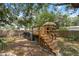 Backyard featuring an above ground pool and a wooden deck with stairs and a tiki umbrella providing a relaxing space at 4522 5Th St, Zephyrhills, FL 33542