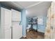 Bathroom features a stackable washer and dryer, and shelving for towels at 4522 5Th St, Zephyrhills, FL 33542