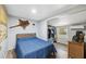 Comfortable bedroom with light gray walls, wood-look flooring, and a window at 4522 5Th St, Zephyrhills, FL 33542