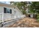 Charming home with wood deck, storage shed, and wooden fence at 4522 5Th St, Zephyrhills, FL 33542