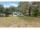 Well-maintained front yard of a single-story home with mature trees and landscaping at 4522 5Th St, Zephyrhills, FL 33542