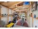 Well-organized garage with ample storage, tools, motorcycle, and a red rug adds functionality at 4522 5Th St, Zephyrhills, FL 33542