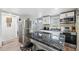 Modern kitchen with stainless steel appliances, granite counters, and an island with seating at 4522 5Th St, Zephyrhills, FL 33542