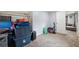 This storage room has carpet flooring, a door, and storage containers at 4522 5Th St, Zephyrhills, FL 33542