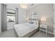Cozy bedroom with a large window, soft carpeting, and a comfortable bed with stylish bedside tables at 4531 Gardner St, Bradenton, FL 34210