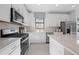 Beautiful kitchen with stainless steel appliances, including gas range and white cabinets and backsplash at 4531 Gardner St, Bradenton, FL 34210
