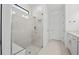 Stylish shower featuring white tiles and a glass door, complemented by modern fixtures and hardware at 4531 Gardner St, Bradenton, FL 34210