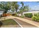 A wooden privacy fence borders a gravel drive and landscaped yard at 4560 7Th N Ave, St Petersburg, FL 33713
