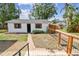 Landscaped yard with a brick walkway to the garage and a modern, metal fence at 4560 7Th N Ave, St Petersburg, FL 33713