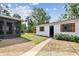View of the detached garage, screened in lanai, and brick path in the backyard at 4560 7Th N Ave, St Petersburg, FL 33713