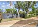 Serene backyard featuring a gravel pathway, mature trees, and a dark wooden fence for added privacy at 4560 7Th N Ave, St Petersburg, FL 33713
