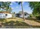 The backyard features a well-kept lawn, screened in porch, shed and privacy fence at 4560 7Th N Ave, St Petersburg, FL 33713