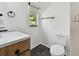 The bathroom features black tile flooring, toilet, wooden vanity, and a window at 4560 7Th N Ave, St Petersburg, FL 33713