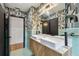 A modern bathroom featuring a double sink vanity, trendy wallpaper, and stylish fixtures at 4560 7Th N Ave, St Petersburg, FL 33713