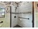 Shower with blue tile and black fixtures, complemented by grab bars for accessibility at 4560 7Th N Ave, St Petersburg, FL 33713