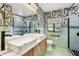 Modern bathroom with dual sinks, patterned wallpaper, and a glass-enclosed shower at 4560 7Th N Ave, St Petersburg, FL 33713