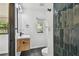 Bathroom featuring black tile flooring, wood vanity, black hardware, walk-in shower and window at 4560 7Th N Ave, St Petersburg, FL 33713