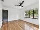 Bright bedroom featuring a ceiling fan, hardwood floors, and large window at 4560 7Th N Ave, St Petersburg, FL 33713