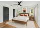 Cozy bedroom with hardwood floors, ceiling fan, and natural light at 4560 7Th N Ave, St Petersburg, FL 33713
