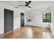 Bedroom features hardwood floors, contemporary fan, two black doors and two black windows at 4560 7Th N Ave, St Petersburg, FL 33713
