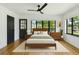 Bright bedroom with hardwood floors, ceiling fan, and a large window offering natural light at 4560 7Th N Ave, St Petersburg, FL 33713