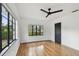 Bedroom featuring hardwood floors, windows with black trim, and contemporary ceiling fan at 4560 7Th N Ave, St Petersburg, FL 33713