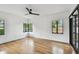 Bright bedroom with hardwood floors, large windows, and modern ceiling fan at 4560 7Th N Ave, St Petersburg, FL 33713