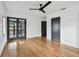 Spacious bedroom with hardwood floors, ceiling fan, and a doorway to the lanai at 4560 7Th N Ave, St Petersburg, FL 33713