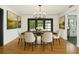 Elegant dining room featuring hardwood floors, modern chandelier, and backyard views at 4560 7Th N Ave, St Petersburg, FL 33713