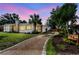 A well-maintained home with a stone chimney, garden beds and a gravel driveway at 4560 7Th N Ave, St Petersburg, FL 33713