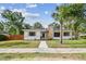 Charming single-story home with a stone chimney, manicured lawn, and inviting walkway at 4560 7Th N Ave, St Petersburg, FL 33713