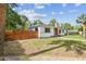 Wonderful home featuring a stone chimney, a privacy fence, and a lush green lawn at 4560 7Th N Ave, St Petersburg, FL 33713