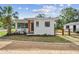 Exterior shot of home with a gravel drive and fenced yard at 4560 7Th N Ave, St Petersburg, FL 33713