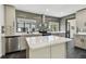 Stylish kitchen with stainless steel appliances, gray backsplash, island, and quartz countertops at 4560 7Th N Ave, St Petersburg, FL 33713